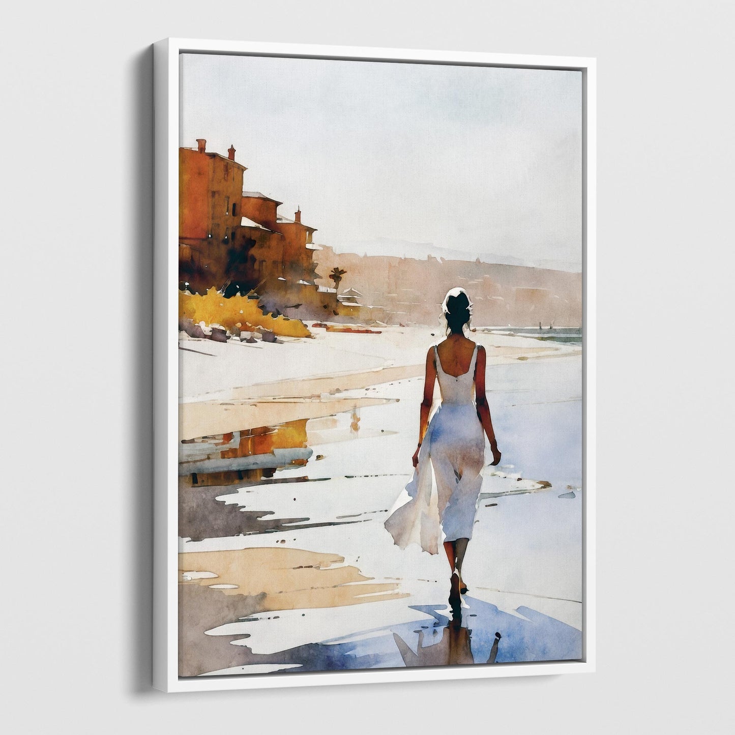 A white framed canvas print of a watercolor painting showing a woman in a flowing white dress walking barefoot along the beach.