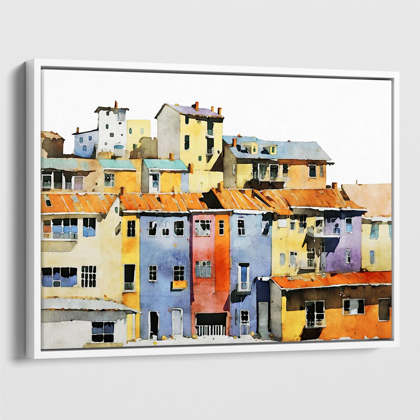 Framed canvas print of a watercolor painting showing a colorful hillside village with vibrant buildings, set in a white frame.