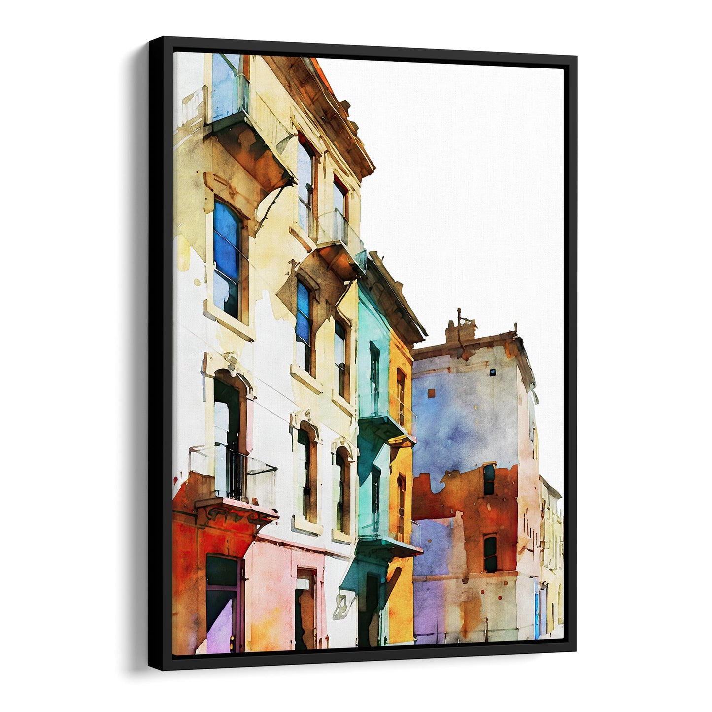 Framed canvas print of a watercolor painting showing colorful buildings with pastel facades, set in a black frame.