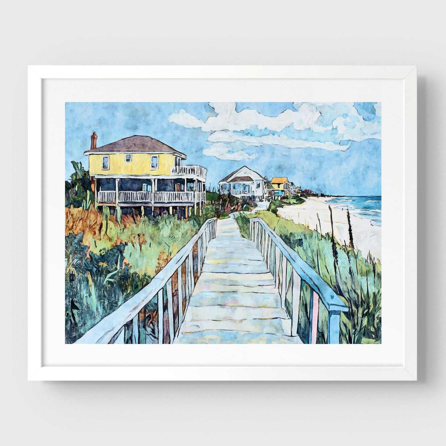 White framed watercolor-style artwork depicting a sunny coastal boardwalk leading to a row of colorful beach houses, with a bright yellow home in the foreground, lush dune grasses on either side, and the ocean visible on the right.