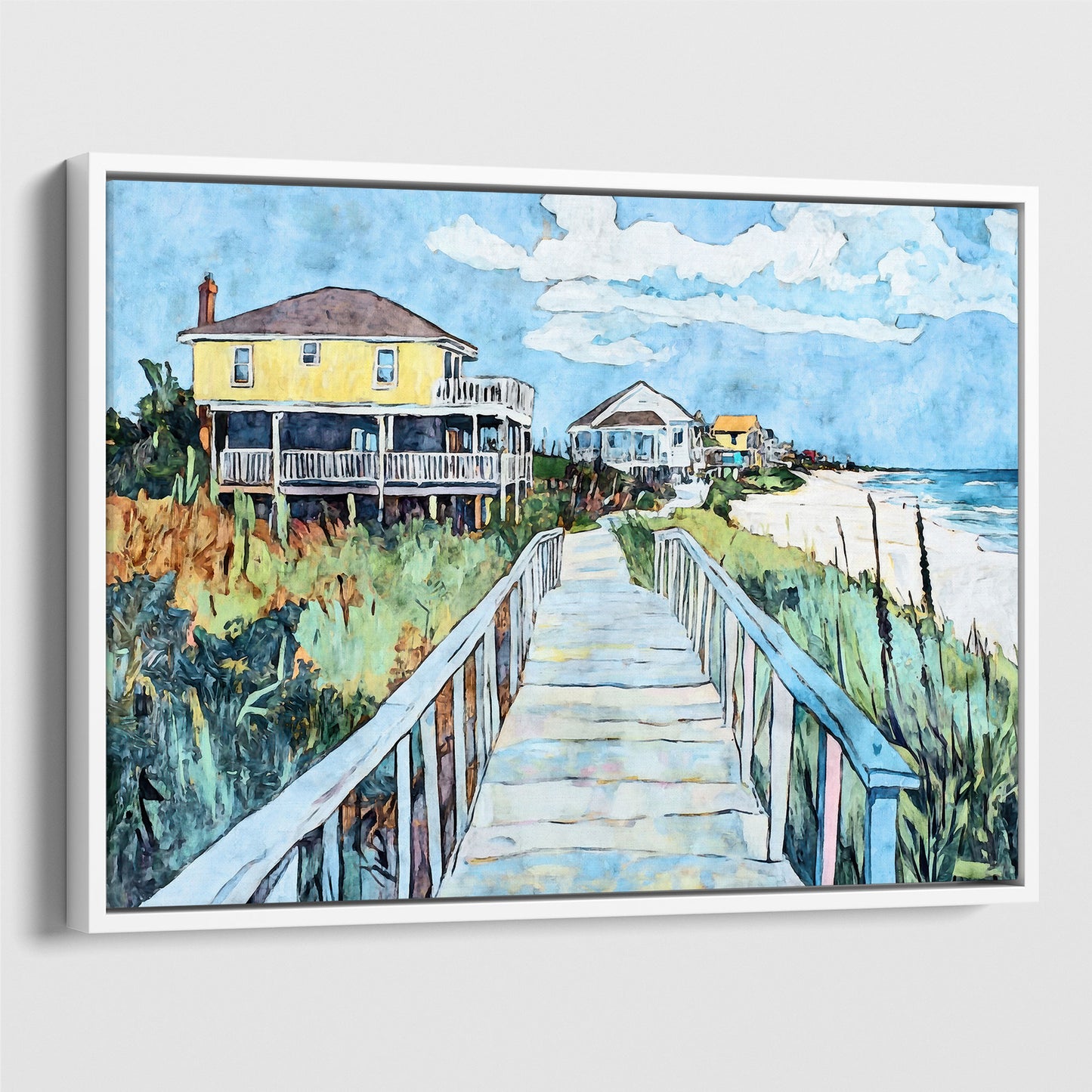 White framed canvas print featuring a watercolor-style boardwalk scene leading to the ocean, with a bright yellow beach house on the left, coastal grasses along the walkway, and vivid blue sky and sea in the background.