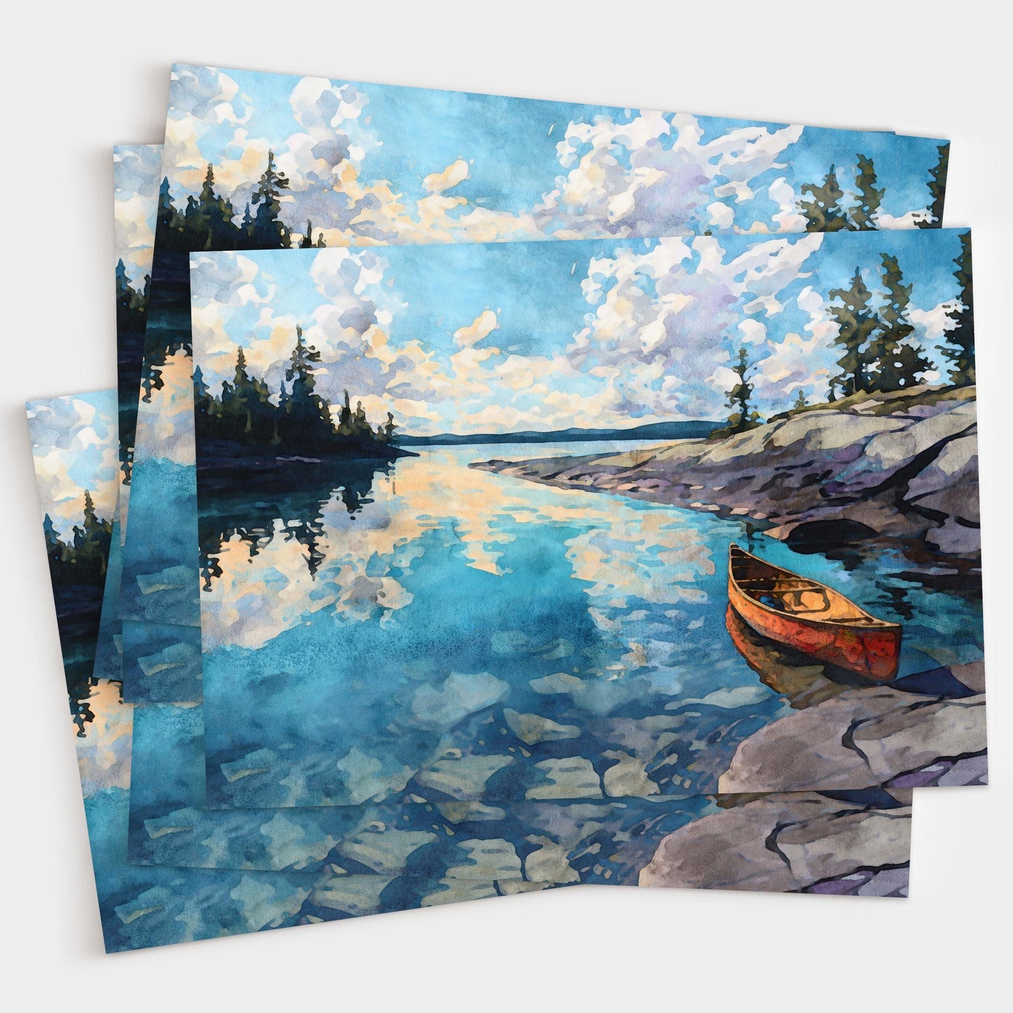 Set of greeting cards featuring a watercolor painting of a red canoe on rocky shore beside a calm blue lake. The water reflects clouds and pine trees along the horizon, creating a peaceful wilderness landscape. Cards are shown stacked with artwork visible.