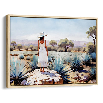 Natural wood framed canvas print of a woman in a white dress and hat standing on a rock in an agave field with trees and mountains in the background.