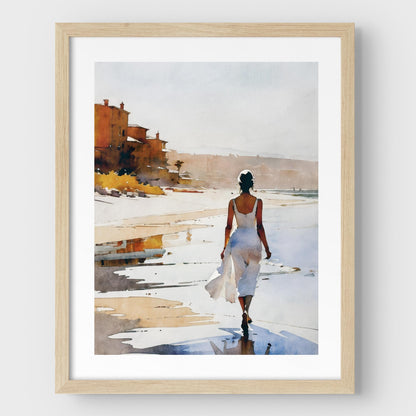 A natural wood framed watercolor painting of a woman in a flowing white dress walking along the shoreline at sunset. 