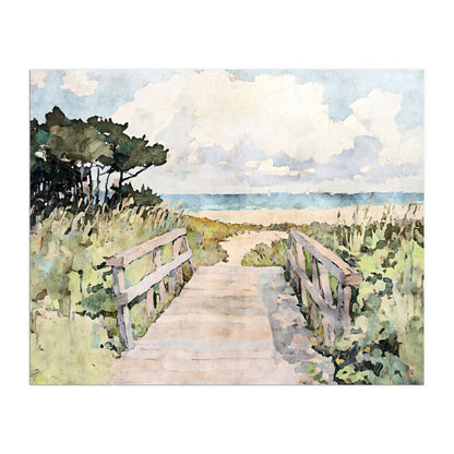 Watercolor-style art print of a sandy boardwalk path leading through grassy dunes toward the ocean, under a sky filled with soft clouds. Weathered wood railings frame the walkway, flanked by lush greenery and windswept sea oats. The distant horizon shows gentle waves and a serene blue sea, evoking the peaceful charm of a coastal escape.