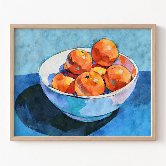 Bowl of oranges still life art print in a natural wood frame with bright orange fruit, white bowl, and blue background.