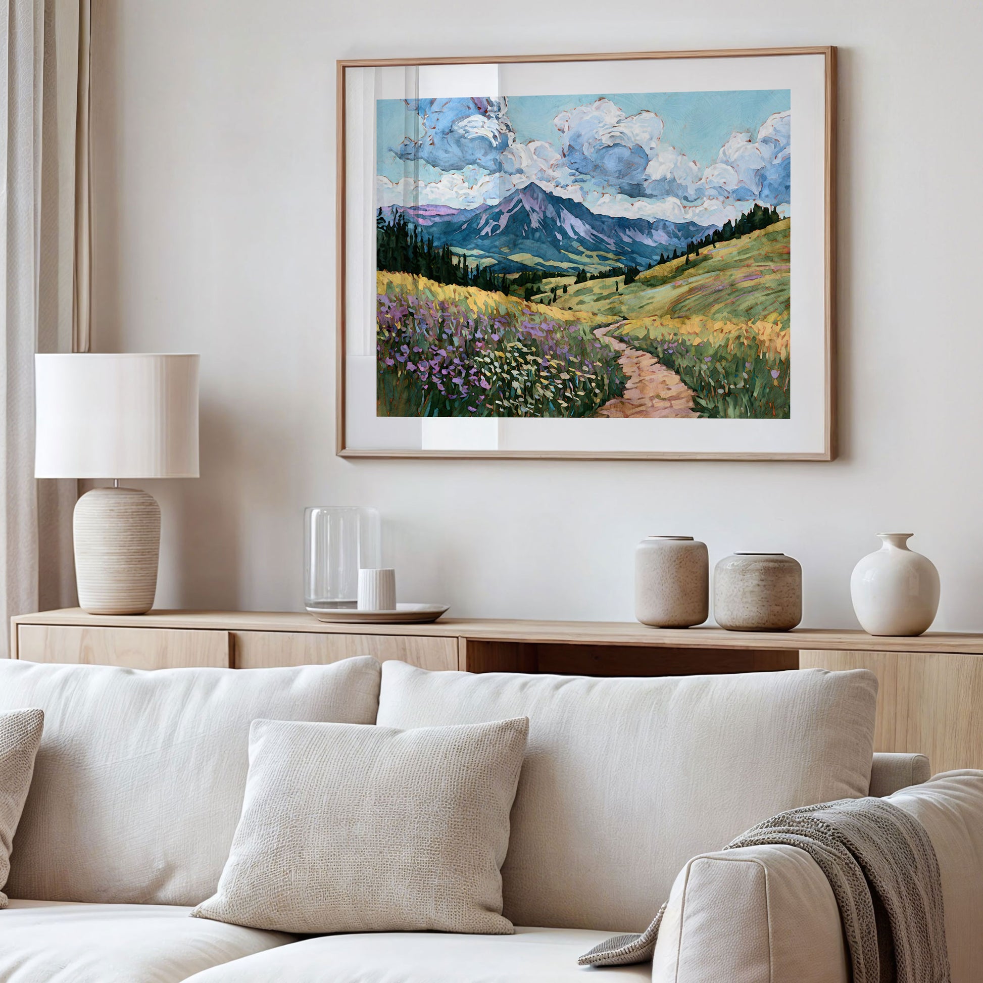 Framed landscape painting above a sofa in a living room