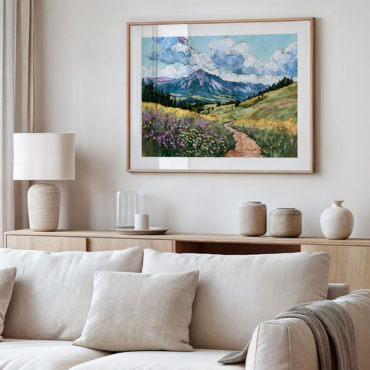 Framed landscape painting above a sofa in a living room