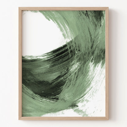 Framed abstract art with green and black brush strokes on a white background