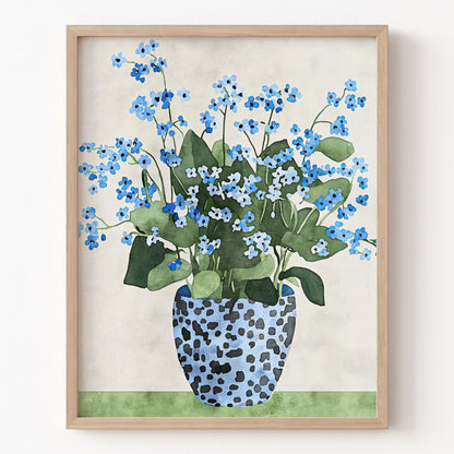 Framed artwork of blue flowers in a spotted vase on a beige background