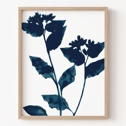 Framed artwork with blue leaf silhouettes on a white background