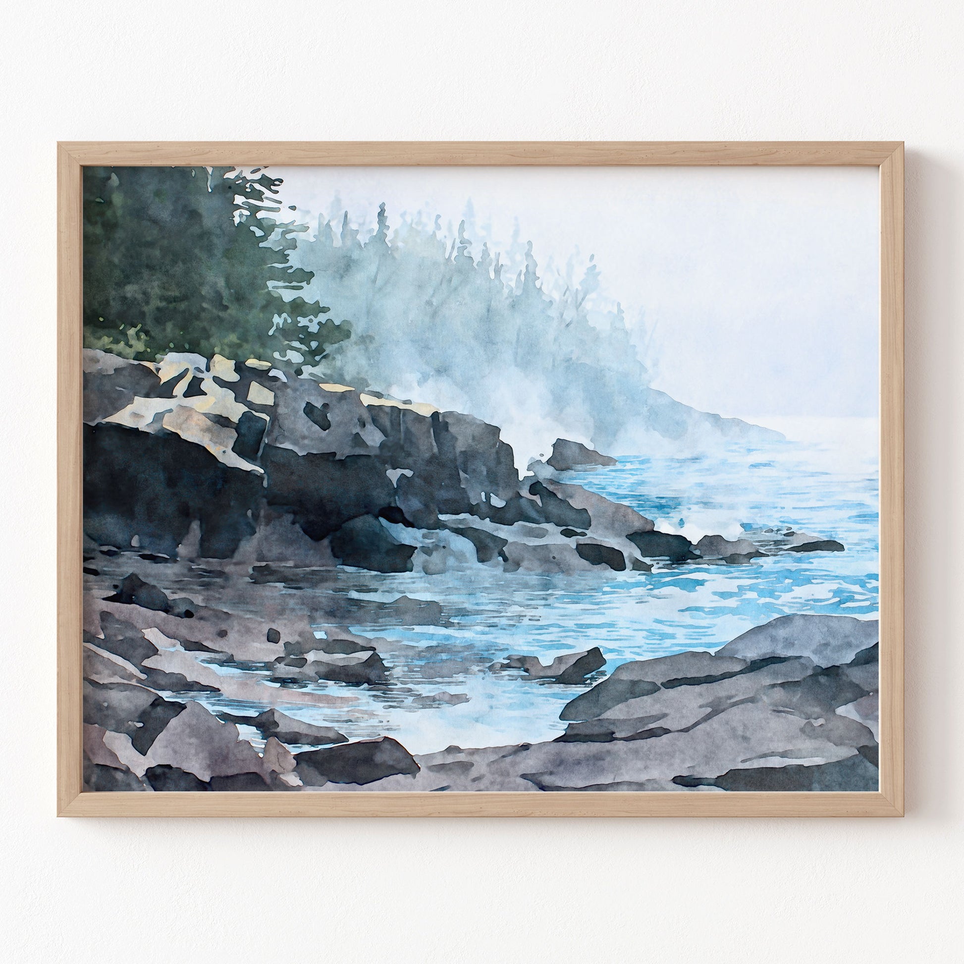 Framed artwork of a coastal scene with rocks and water.