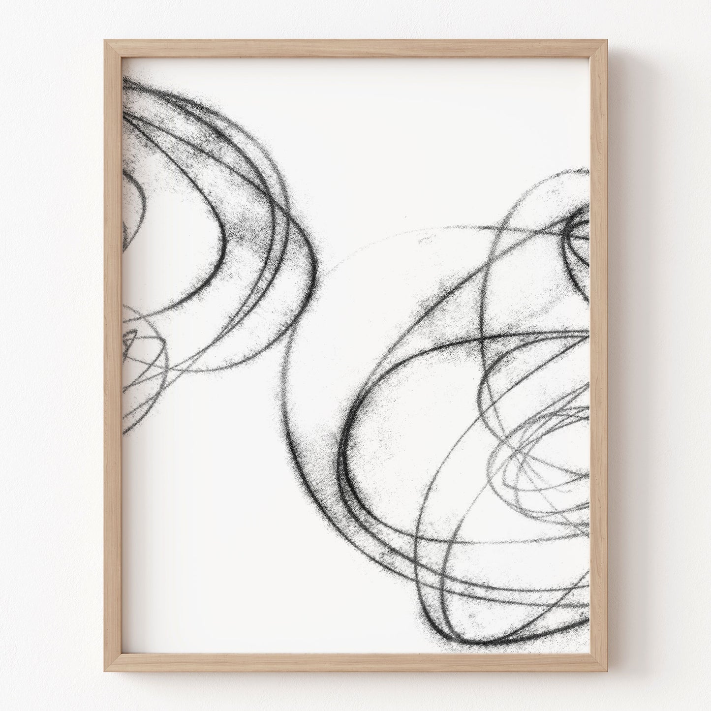 Framed abstract black and white artwork on a white wall