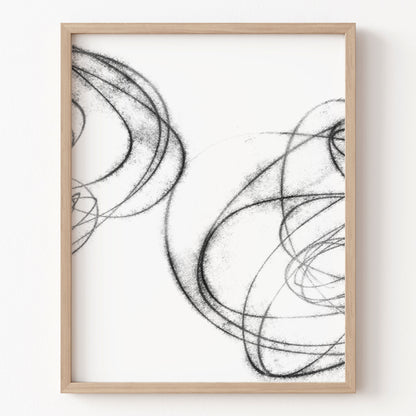 Framed abstract black and white artwork on a white wall