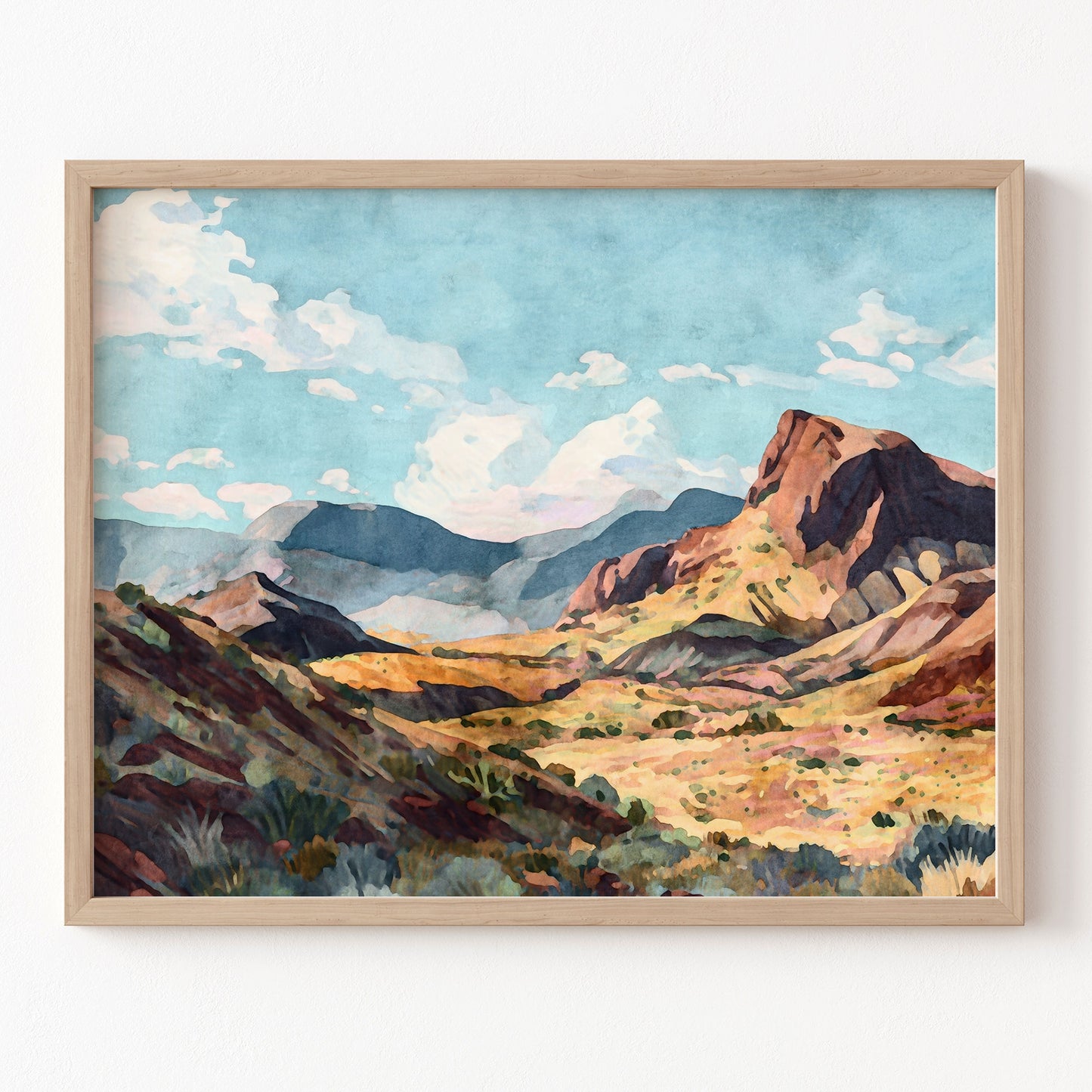Framed painting of a mountain landscape with a blue sky.