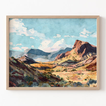 Framed painting of a mountain landscape with a blue sky.