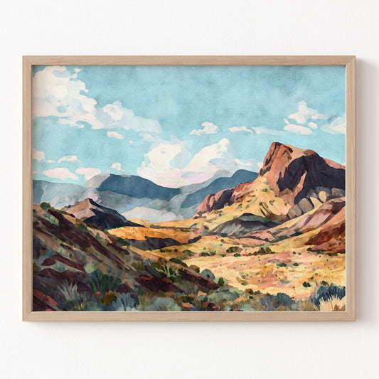 Framed painting of a mountain landscape with a blue sky.