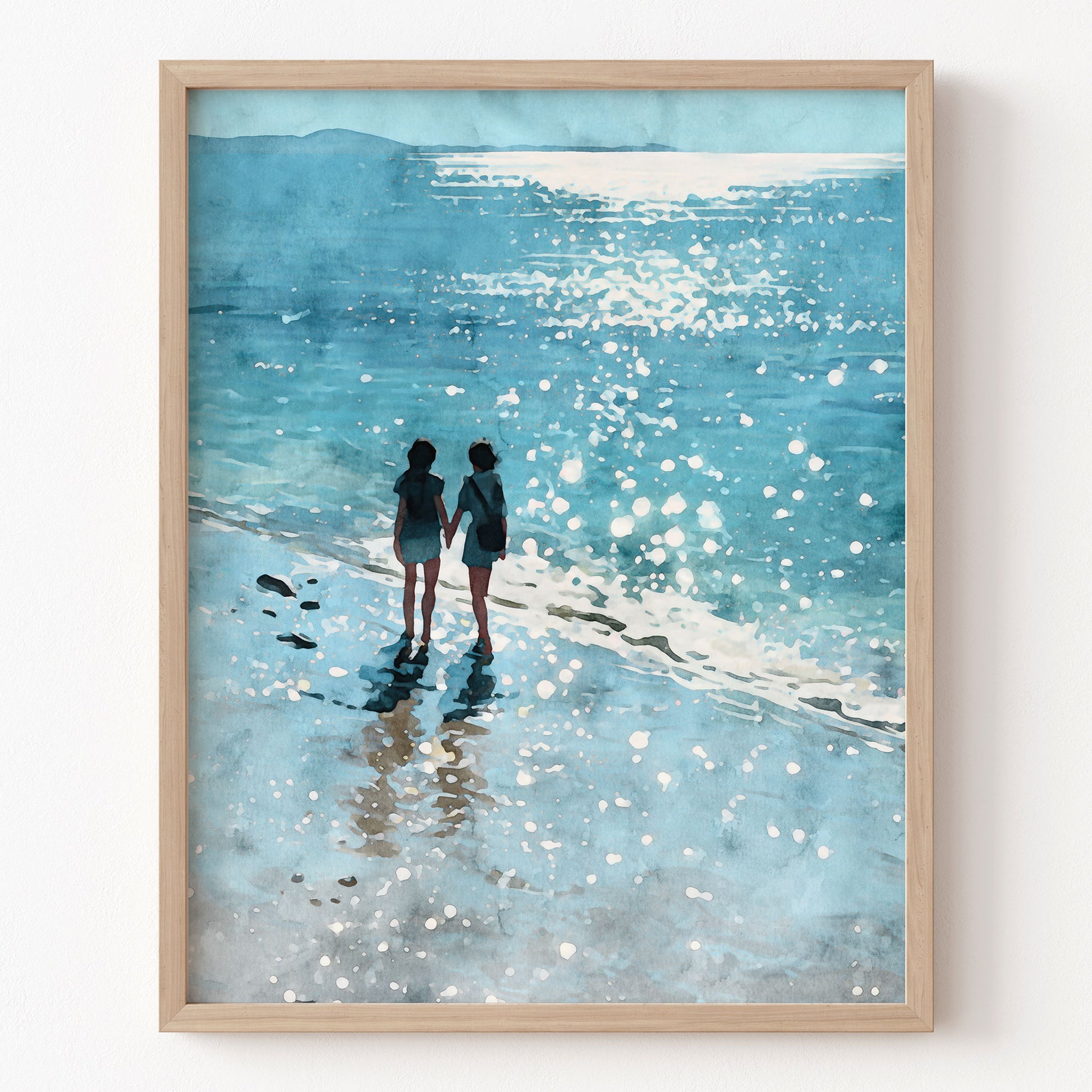 Watercolor-style art print of two women walking hand in hand along a sunlit shoreline, surrounded by shimmering waves and soft reflections in shades of blue. Set against a white background for a clean, modern presentation.