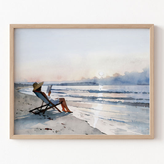 Framed artwork of a person sitting on a beach chair by a body of water.
