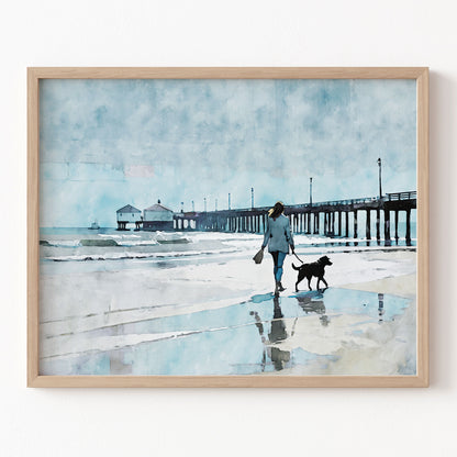 Framed artwork of a person walking a dog on a beach with a pier in the background.