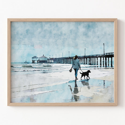 Framed artwork of a person walking a dog on a beach with a pier in the background.