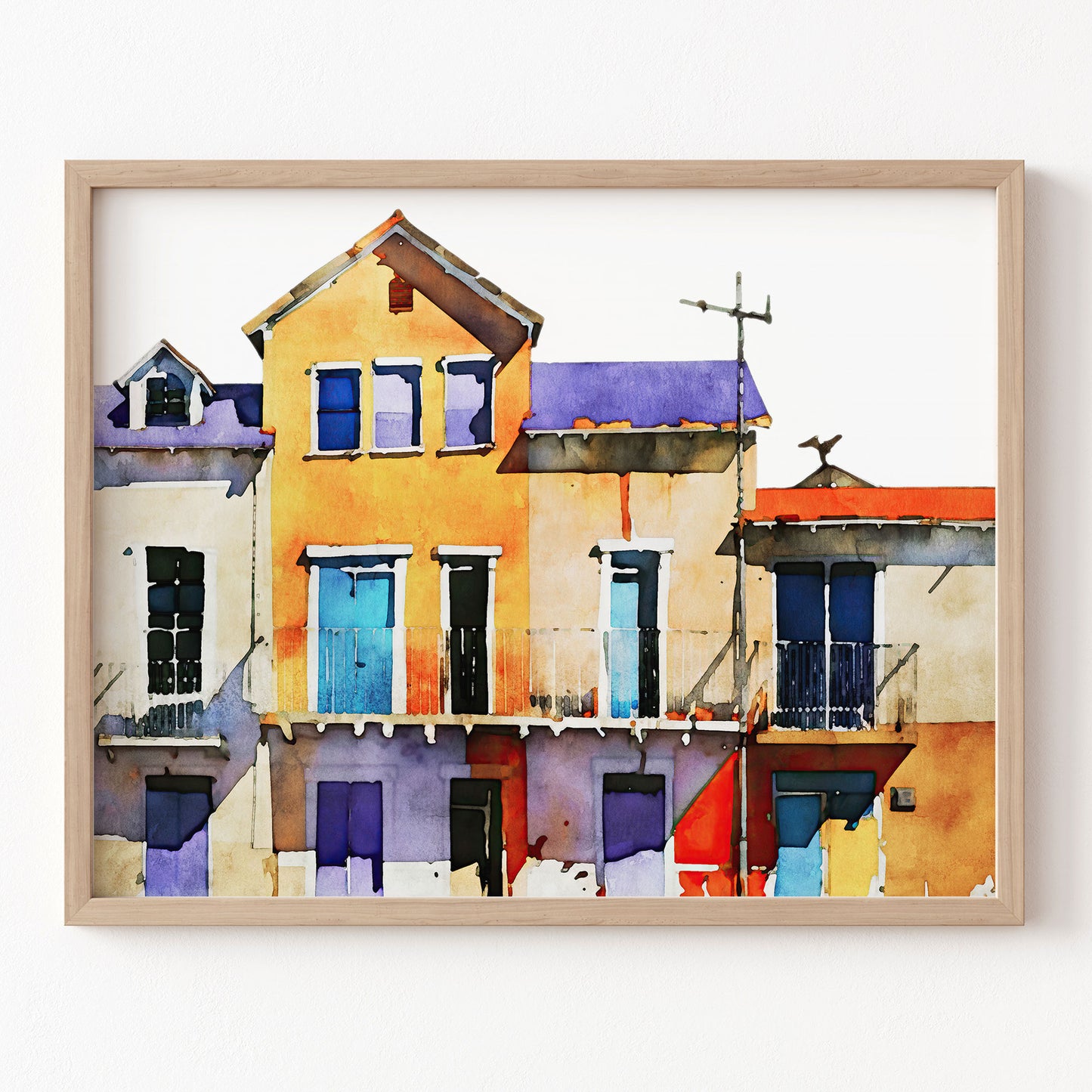 Framed artwork of colorful houses on a white wall