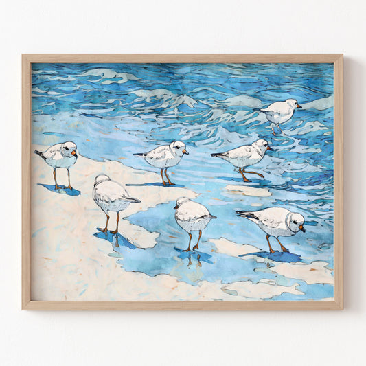 Framed artwork of birds on a beach with blue water