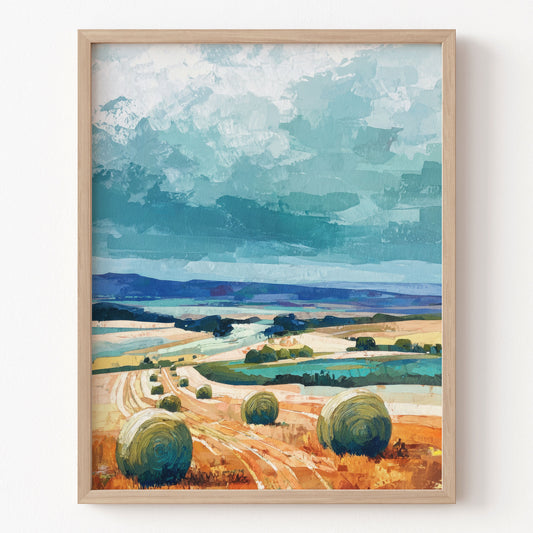 Framed artwork of a landscape with fields, hay bales, and a blue sky.