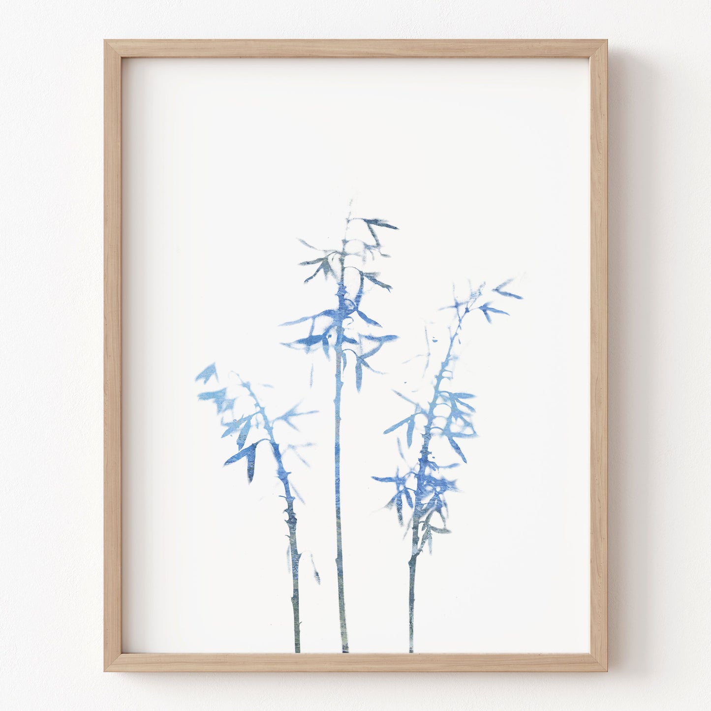Framed artwork of blue bamboo on a white background