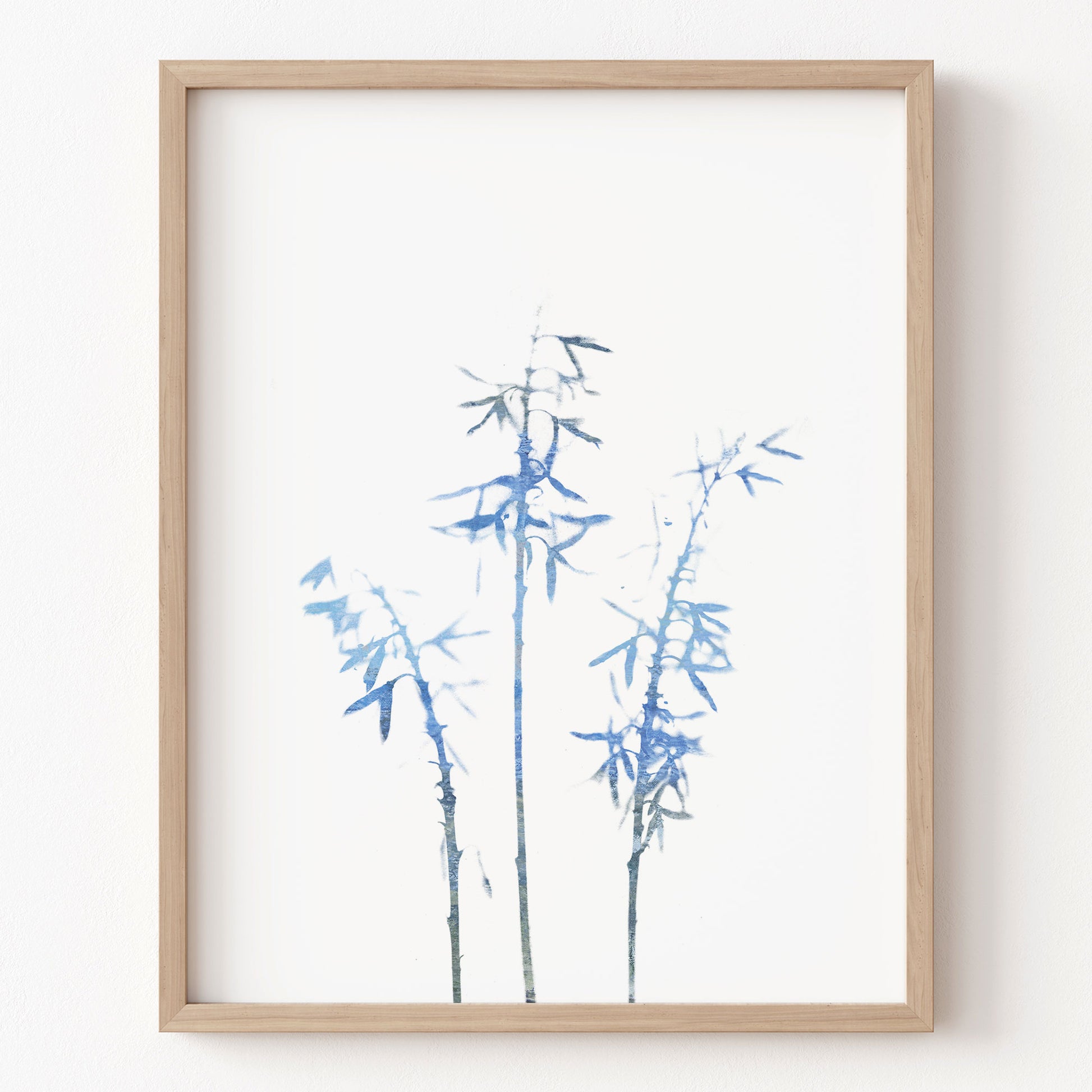 Framed artwork of blue bamboo on a white background