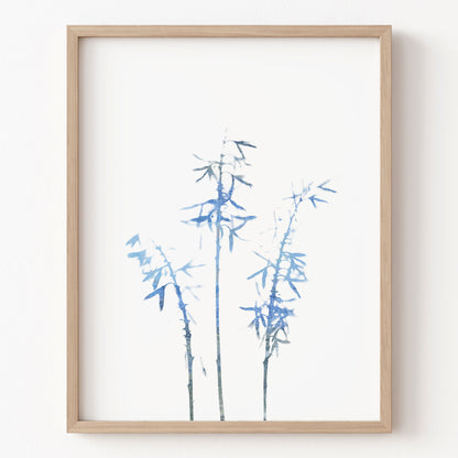 Framed artwork of blue bamboo on a white background