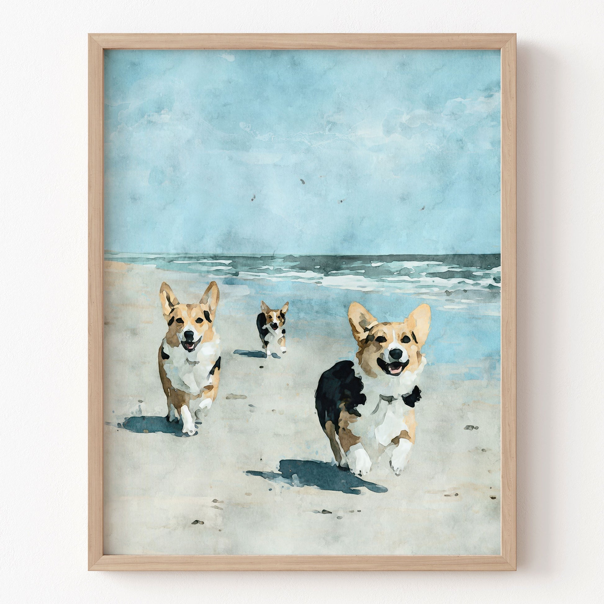 Framed artwork of three corgis running on a beach