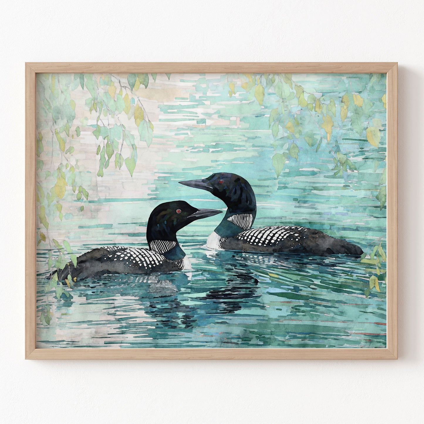 Framed artwork of two loons swimming in water with a light blue and green background.