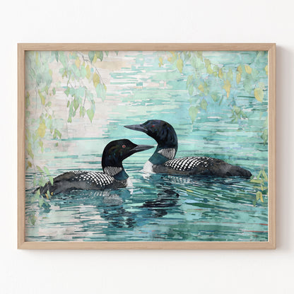 Framed artwork of two loons swimming in water with a light blue and green background.