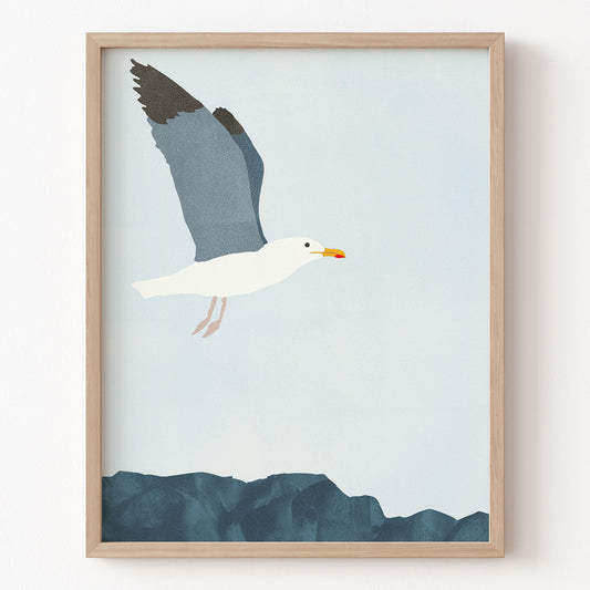 Framed artwork of a seagull flying over water on a light blue background