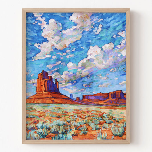 Framed painting of a desert landscape with a blue sky and red rock formations.