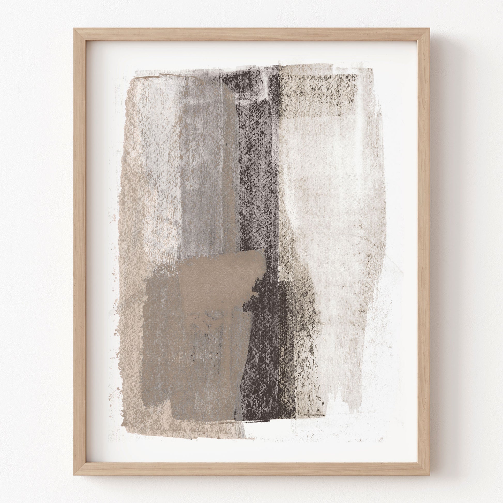 Abstract art print with brown and beige tones in a wooden frame on a white wall.