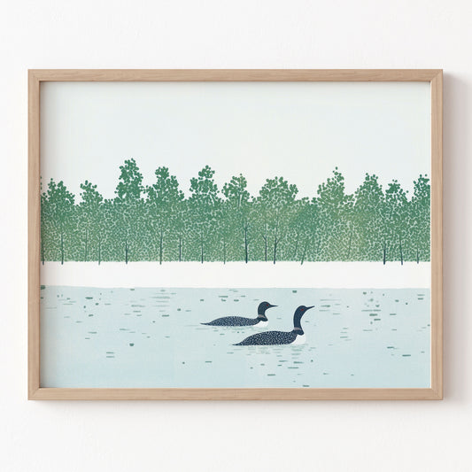 Framed artwork of two loons on a lake with a forest in the background