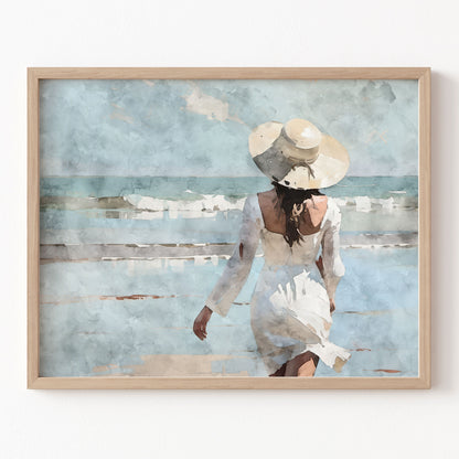 Framed artwork of a woman in a white dress and hat on a beach.