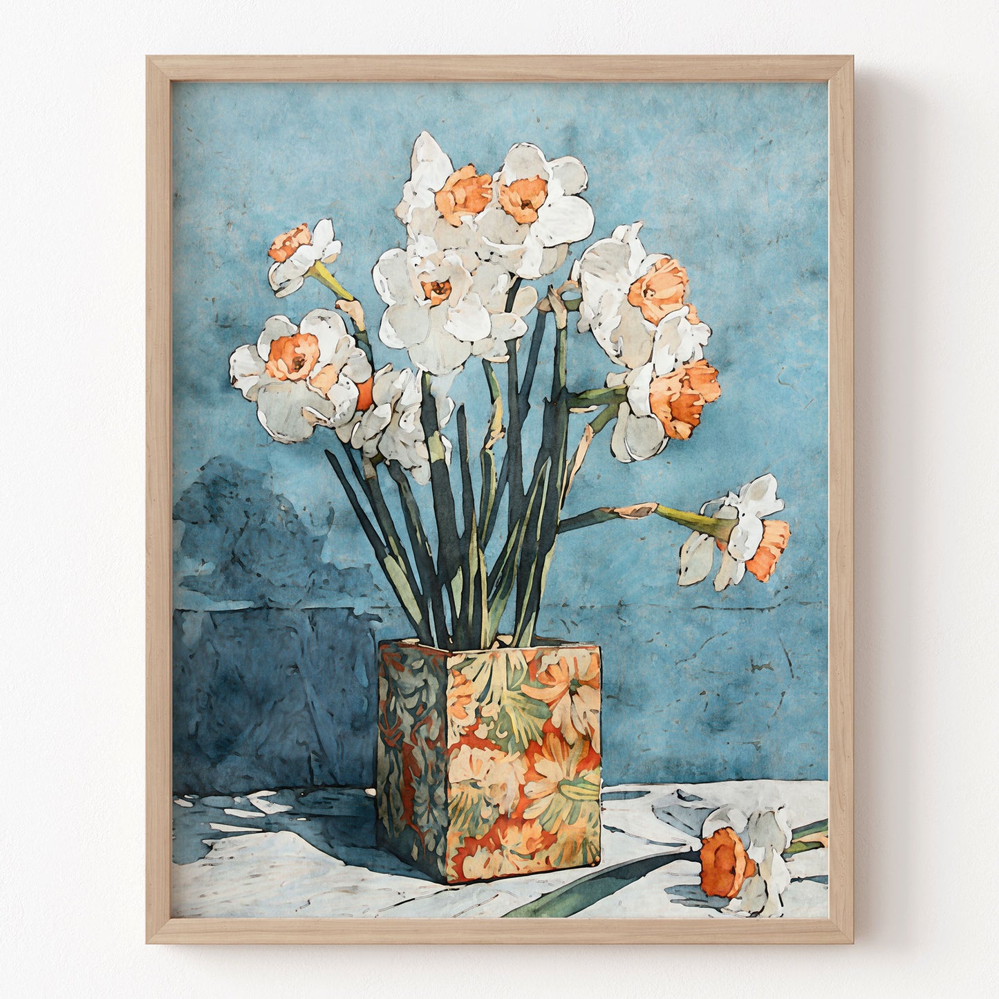 Framed artwork of flowers in a vase against a blue wall.