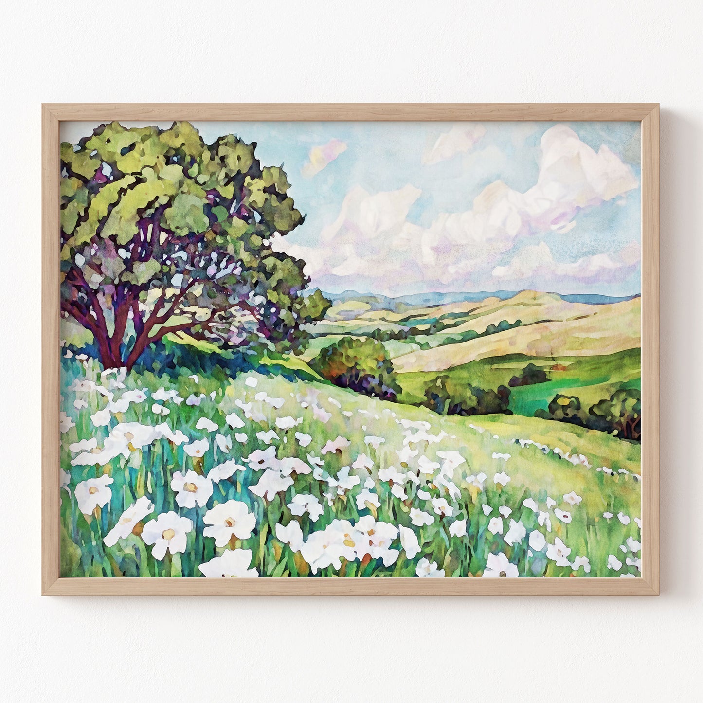 Framed painting of a landscape with trees, flowers, and rolling hills.