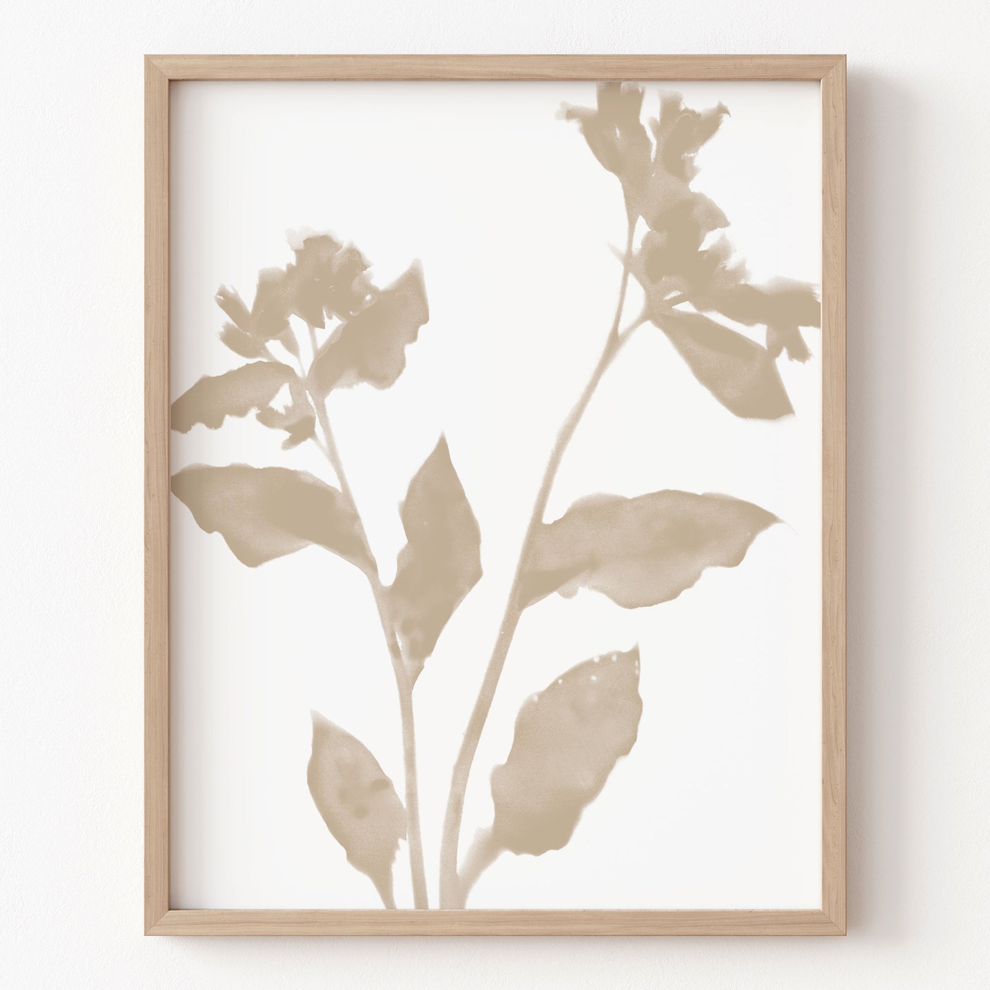 Framed botanical art print with beige leaves on a white background
