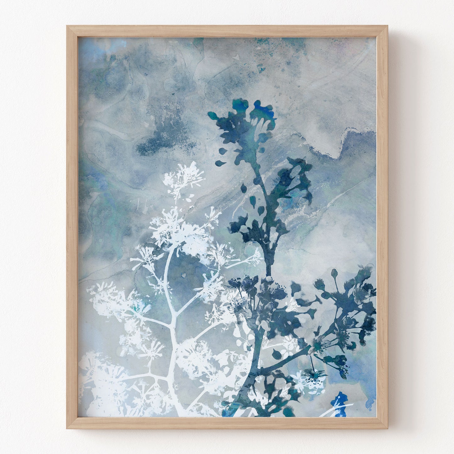 Framed artwork with blue and white abstract design on a light background