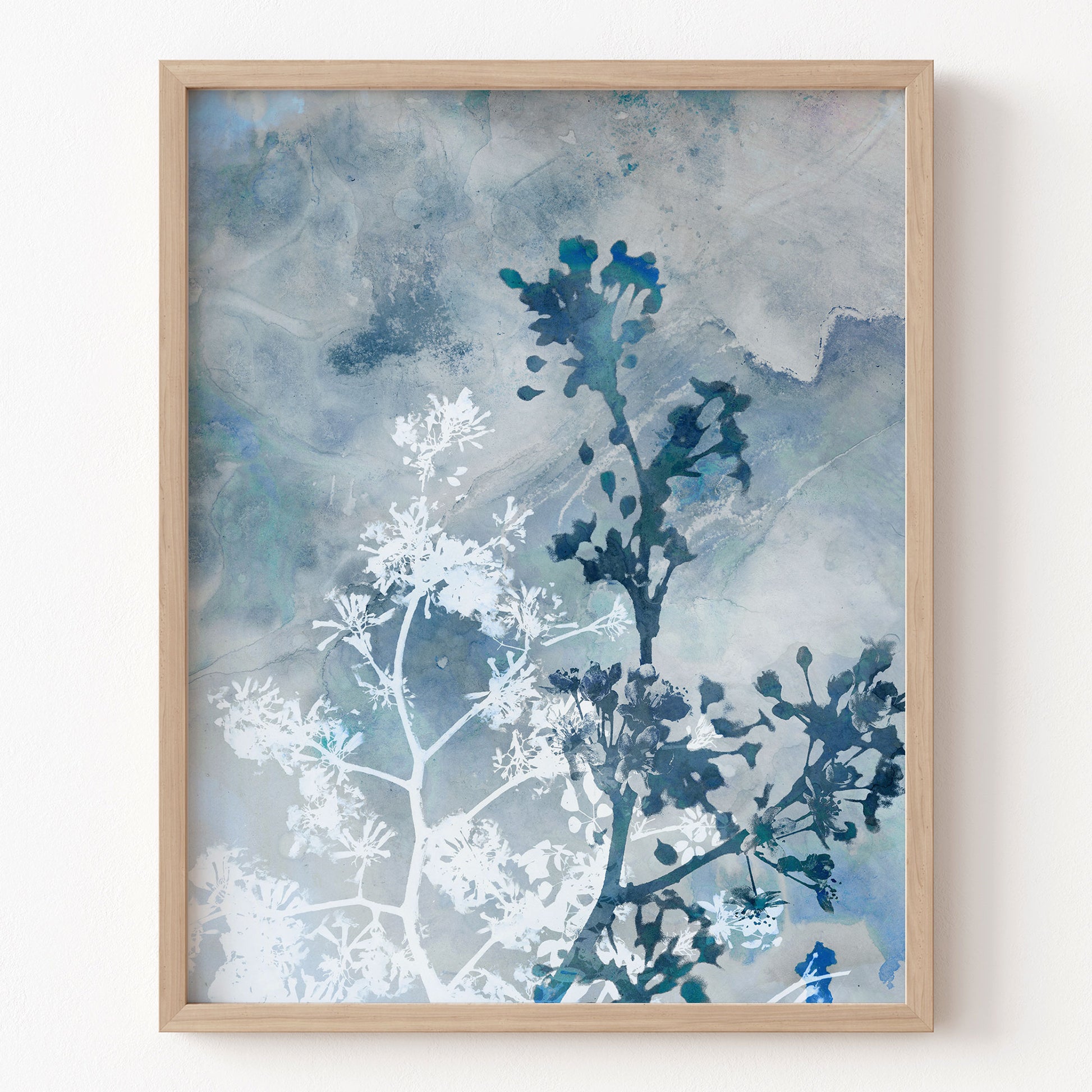 Framed artwork with blue and white abstract design on a light background