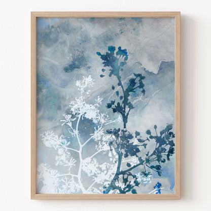 Framed artwork with blue and white abstract design on a light background