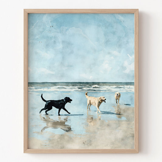 Framed artwork of three dogs on a beach with a blue sky.