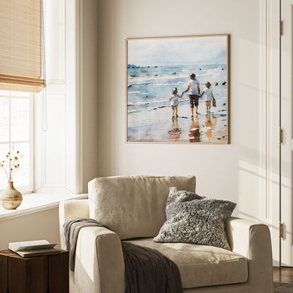 Framed watercolor painting of a woman and two children walking along the shoreline, mounted on a beige wall above a cozy armchair with textured pillows.