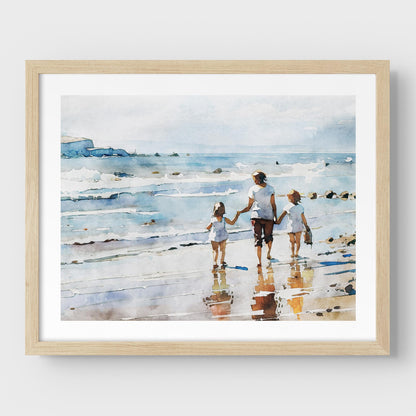 Framed watercolor painting of a woman and two children walking along the shoreline, mounted on a white wall with a natural wood frame.