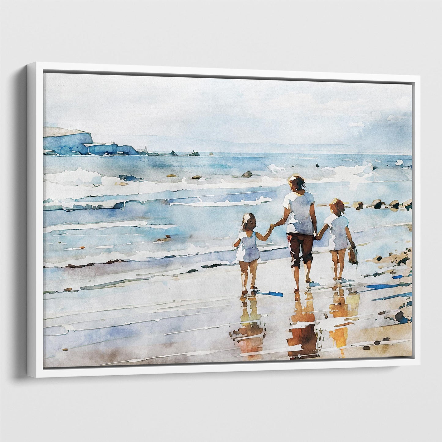 White framed canvas print of a watercolor painting depicting a woman and two children walking hand in hand along the shoreline, reflecting in the wet sand.