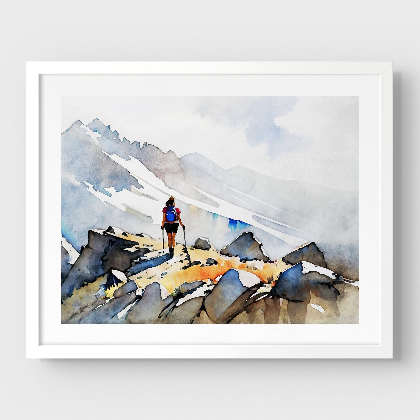 A white framed artwork of a hiker with trekking poles and a blue backpack on a rocky mountain path.
